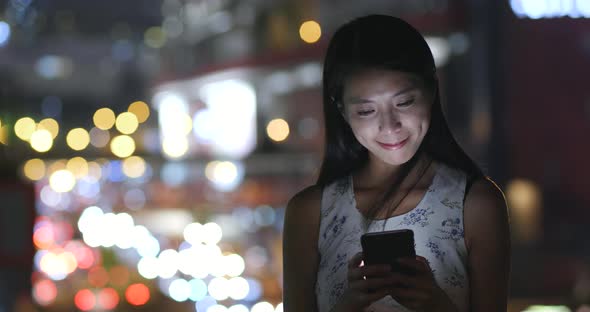 Woman use of mobile phone at night 