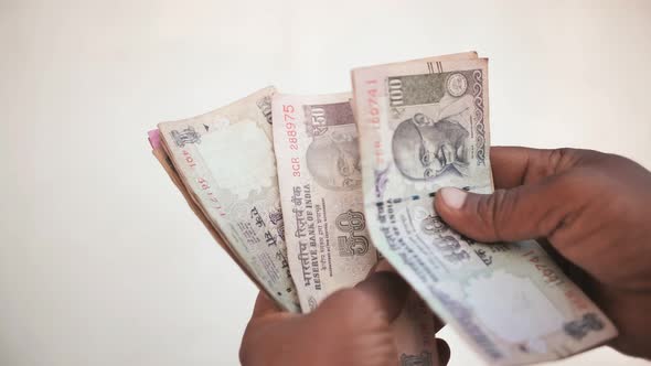 Man Recounts Indian Rupee Money