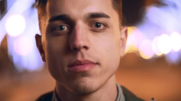 Portrait Closeup of Handsome Young Man Taking Off Eyeglasses and Smiling at you While Strolling