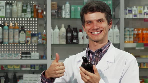 Cheerful Pharmacist Showing Thumbs Up While Working at the Drugstore