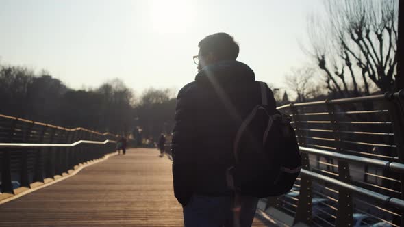 Man Is Walking Over Bridge in Town