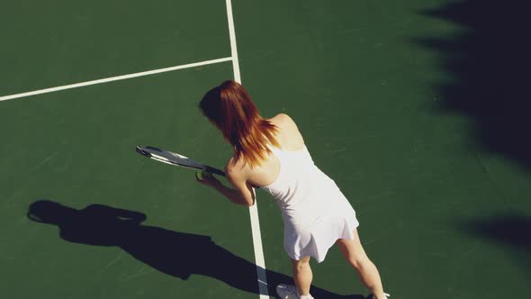 Woman playing tennis on a sunny day