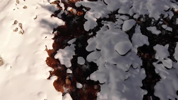 Aerial Top View Over Snowcovered Coast Mountain River Stream