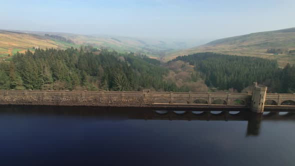 Aerial view reveal Scar house reservoir landmark flying across vibrant Yorkshire valley countryside