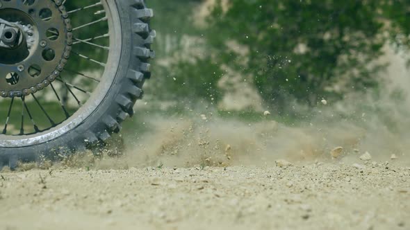 Wheel of Motocross Bike Starting to Spin and Kicking Up Ground or Dirt