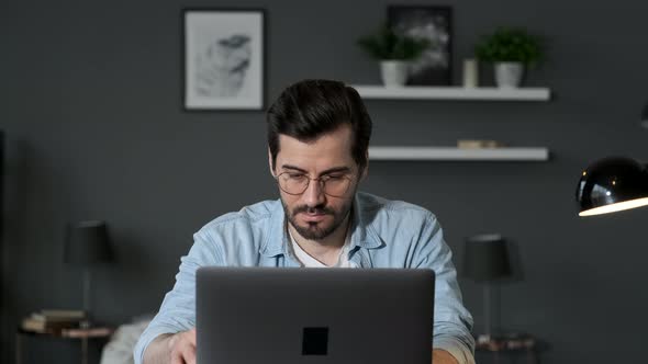 Young man freelancer student using laptop studying online working from home in internet