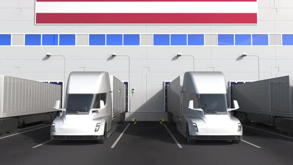 Modern Trucks at Warehouse Bays with Flag of the USA