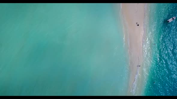 Aerial drone shot scenery of paradise coast beach adventure by blue water with white sandy backgroun