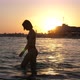 Glamour Girl Going in Sparkling River Waters at City Quay at Sunset in Slo-mo - VideoHive Item for Sale