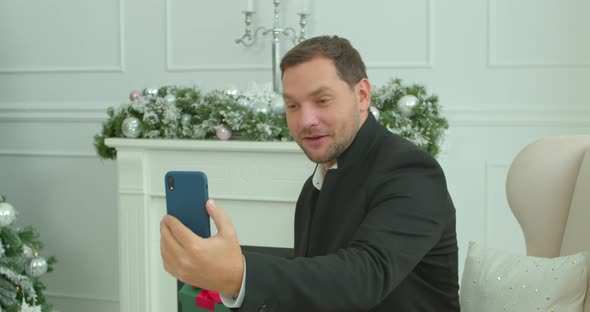 Close-up of Happy Young Man Communicating By Video Call. Young Man Waving at Camera and Talking on