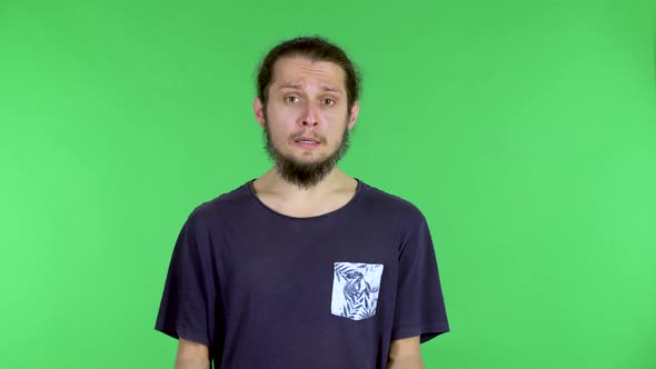 Portrait of a Man Posing in a Black Tshirt on a Green Screen in the Studio