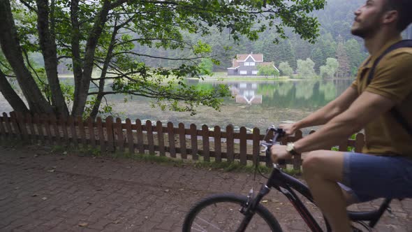 Cycling by the lake against the landscape.