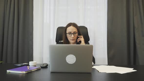 Businesswoman talking on phone in her office. Business concept