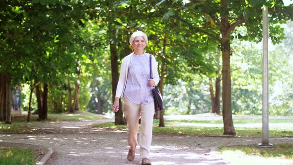 Happy Senior Woman Walking Along Summer Park 2