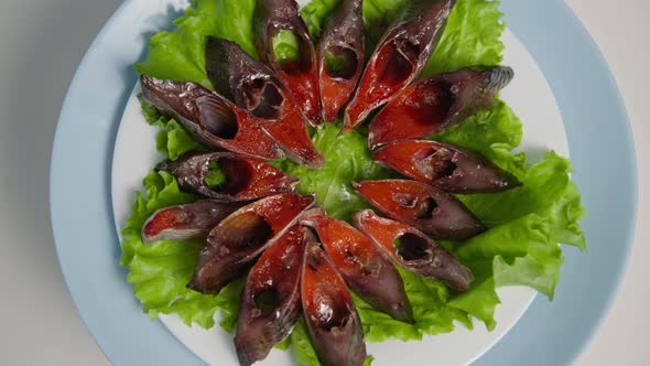 Healthy Food Delicious Slices of Fish with Caviar Laid Out on Lettuce Leaf on Plate Background