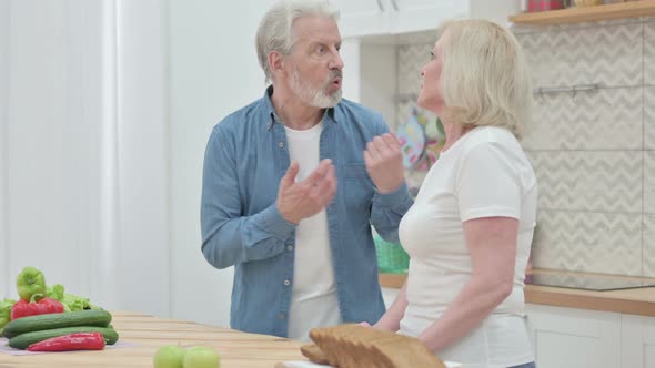 Happy Couple Talking While Standing in Kitchen