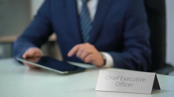 Chief Executive Officer of Company Working on Tablet Pc, Viewing Files on Screen