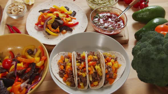 Tacos and Ingredients for Mexican Food on Table