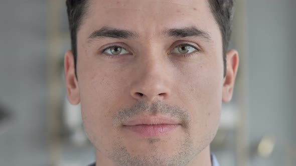 Close Up of Young Man Face Looking at Camera