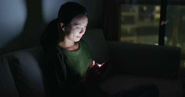 Woman use of mobile phone at home