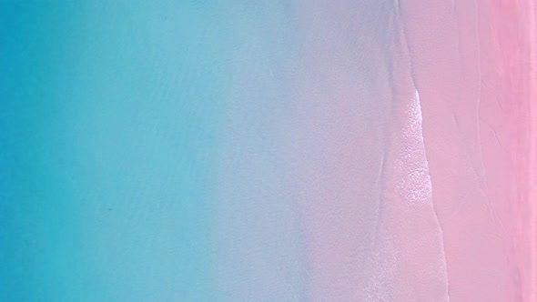 4K Aerial view top view of drone, blue sea waves and beautiful pink sand beach.