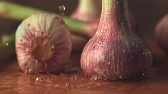 Super Slow Motion Water Droplets Fall on the Garlic