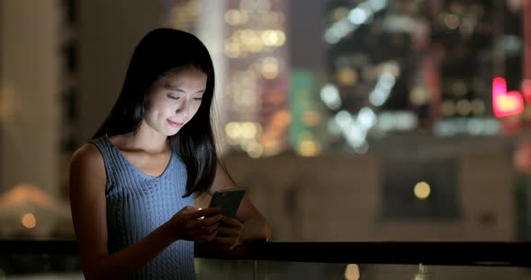 Woman use of smart phone in the evening 