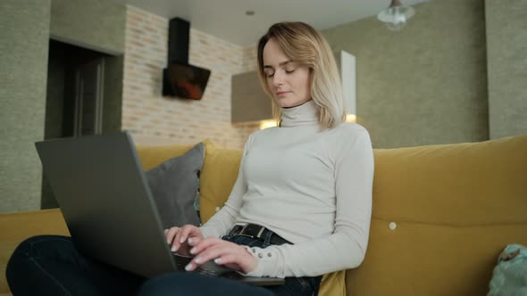 Remote Job, A Woman Is Working with Documents on Laptop Remotely at Home, A Businesswoman Man Is