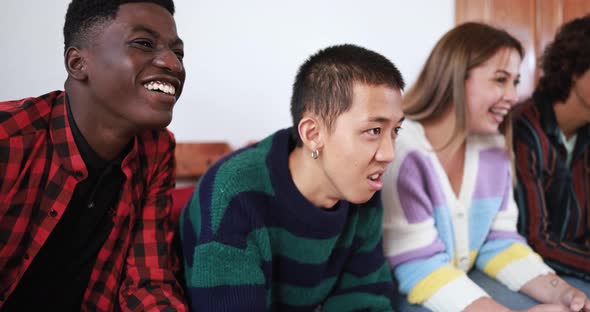 Multiracial friends playing with video games at home - Technology and generation z people concept