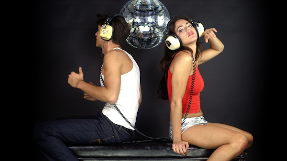 Young Couple Dancing With Retro Headphones 1