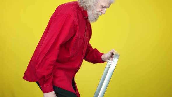 Side View of Confident Senior Man Walking Up the Ladder with Briefcase