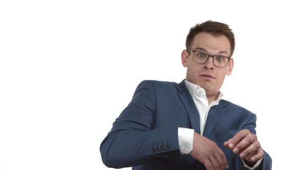 Handsome Businessman in Glasses and Blue Suit Jumping Startled Seeing Something Scary