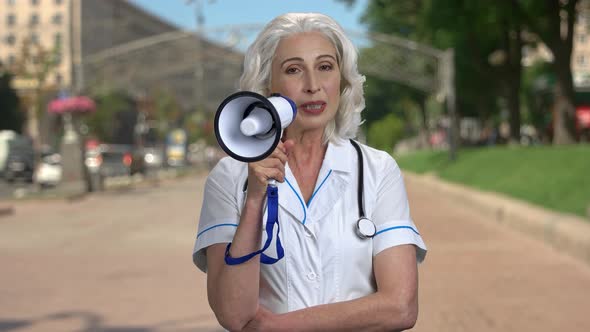 Female Doctor Making an Announcement Through Megaphone