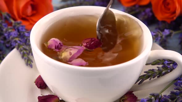 Provencal style composition: white cap of  tea with fragrant rose buds, fresh rose flowers