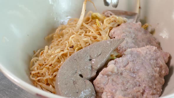 Close-up Footage of Thai Styled Egg Noodles With Minced Pork Cake and Pork Liver, Thailand Popular S