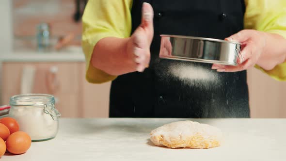 Sifting Flour on Dough Using Metallic Sieve