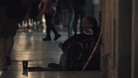 Man beggar sitting in busy street