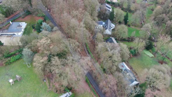 Aerial View of Big Villas with Garden Surrounded By Forest During Winter Season