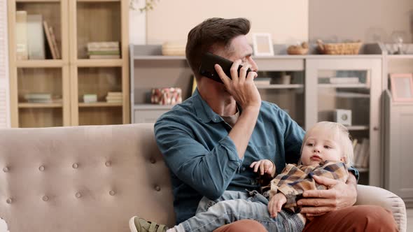 Father Having Phone Call on Couch