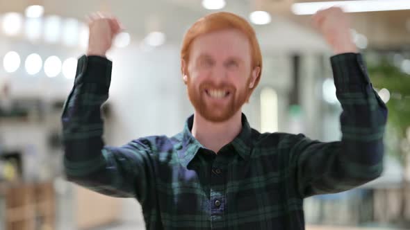 Portrait of Excited Beard Redhead Man Celebrating Success, Cheering