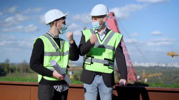 Two Positive Intelligent Men in Coronavirus Face Masks Discussing Urban Planning Gesturing Yes