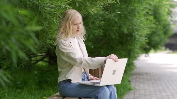 Young Woman with Laptop in the Park