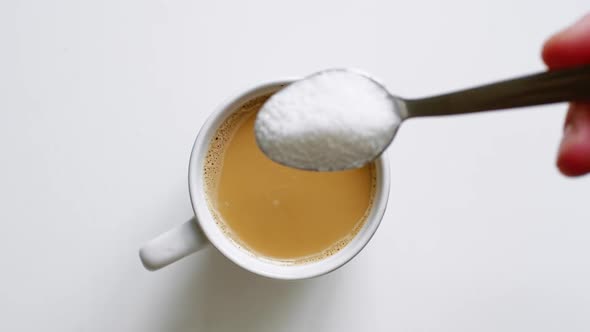 Close Up Shot of Sugar Being Poured Into Coffee