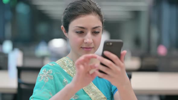 Young Indian Woman Celebrating on Smartphone