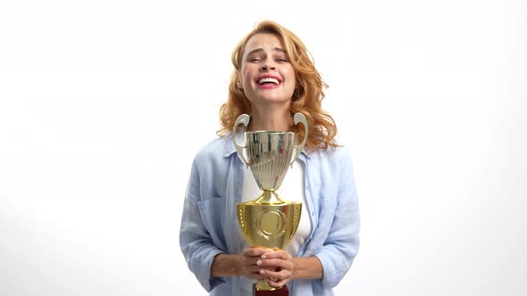 Happy Woman with Golden Cup Rejoicing Isolated on White Success