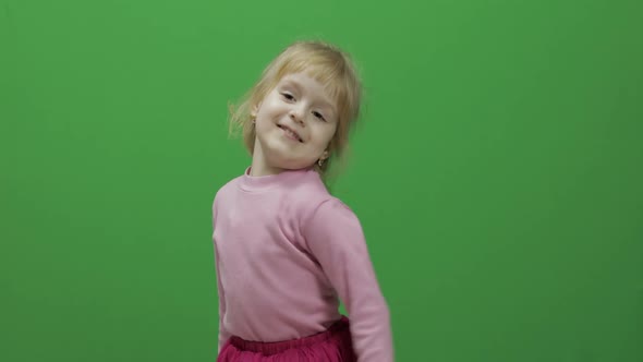Happy Three Years Old Girl. Cute Blonde Child. Dancing and Make Faces