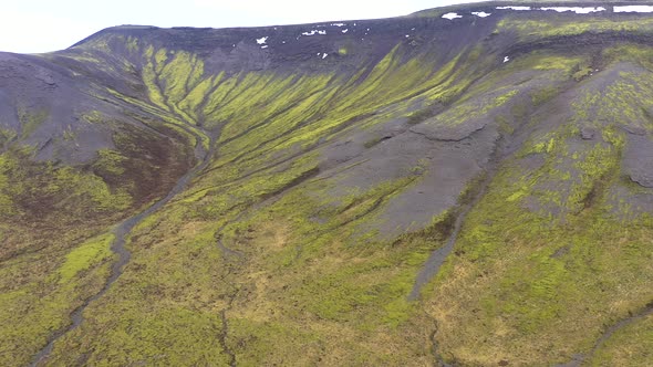 Flying Over a Volcanic Field with Vibrant Green Moss in Iceland