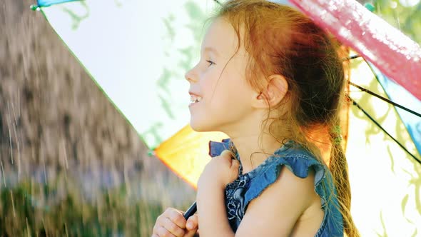 Portrait in Profile of a Carefree Girl Who Enjoys the Rain.