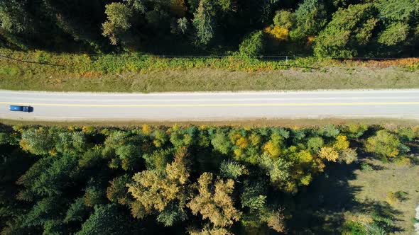 Aerial view of vehicle moving on road at countryside 4k