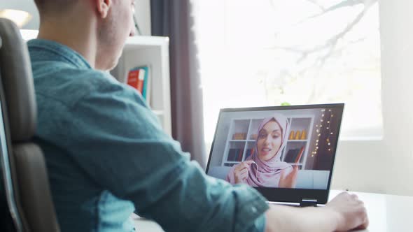 Young male entrepreneur works at home office at the computer.